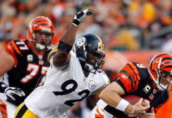 CINCINNATI - SEPTEMBER 27:  Carson Palmer #9 of the Cincinnati Bengals runs with the ball while defended by James Harrison #92 of the Pittsburgh Steelers at Paul Brown Stadium on September 27, 2009 in Cincinnati, Ohio.  The Bengals won 23-20.  (Photo by Andy Lyons/Getty Images)