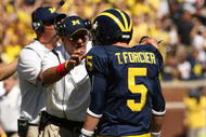ANN ARBOR, MI - SEPTEMBER 19: Head coach Rich Rodriguez of the Michigan Wolverines talks with quarterback Tate Forcier #5 during the game with the Eastern Michigan Eagles at Michigan Stadium on September 19, 2009 in Ann Arbor, Michigan. Michigan won 45-17. (Photo by Stephen Dunn/Getty Images)