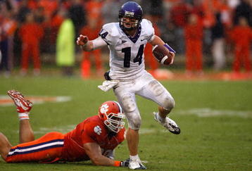 CLEMSON, SC - SEPTEMBER 26:  Andy Dalton #14 of the TCU Horned Frogs runs with the ball as Miguel Chavis #89 of the Clemson Tigers tries to tackle him during their game at Memorial Stadium on September 26, 2009 in Clemson, South Carolina.  (Photo by Streeter Lecka/Getty Images)