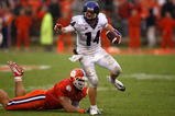 CLEMSON, SC - SEPTEMBER 26:  Andy Dalton #14 of the TCU Horned Frogs runs with the ball as Miguel Chavis #89 of the Clemson Tigers tries to tackle him during their game at Memorial Stadium on September 26, 2009 in Clemson, South Carolina.  (Photo by Streeter Lecka/Getty Images)