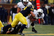 ANN ARBOR, MI - OCTOBER 24: Mike Martin #68 of the Michigan Wolverines tackles Brandon Beachum #3 of the Penn State Nittany Lions on October 24, 2009 at Michigan Stadium in Ann Arbor, Michigan. (Photo by Gregory Shamus/Getty Images)