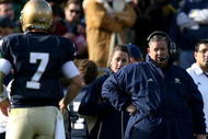 SOUTH BEND, IN - OCTOBER 17: Head coach Charlie Weis of the Notre Dame Fighting Irish looks at quarterback Jimmy Clausen #7 during the second quarter against the USC Trojans at Notre Dame Stadium on October 17, 2009 in South Bend, Indiana. (Photo by Jonathan Daniel/Getty Images)