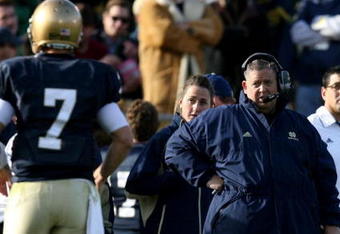 SOUTH BEND, IN - OCTOBER 17: Head coach Charlie Weis of the Notre Dame Fighting Irish looks at quarterback Jimmy Clausen #7 during the second quarter against the USC Trojans at Notre Dame Stadium on October 17, 2009 in South Bend, Indiana. (Photo by Jonathan Daniel/Getty Images)