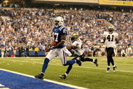 INDIANAPOLIS - SEPTEMBER 06:  Reggie Wayne #87 of the Indianapolis Colts runs in for a touchdown in front of Marques Colston #12 of the New Orleans Saints in the first NFL game of the season at the RCA Dome on September 6, 2007 in Indianapolis, Indiana.  (Photo by Jamie Squire/Getty Images)