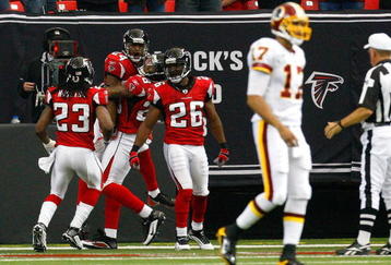ATLANTA - NOVEMBER 08:  Tye Hill #24 of the Atlanta Falcons celebrates his interception return for a touchdown against quarterback Jason Campbell #17 of the Washington Redskins at Georgia Dome on November 8, 2009 in Atlanta, Georgia.  (Photo by Kevin C. Cox/Getty Images)