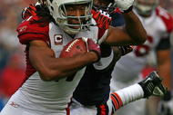 CHICAGO - NOVEMBER 08: Larry Fitzgerald #11 of the Arizona Cardinals shakes off a tackle attempt by Charles Tillman #33 of the Chicago Bears to score a touchdown at Soldier Field on November 8, 2009 in Chicago, Illinois. (Photo by Jonathan Daniel/Getty Images)