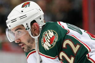 ANAHEIM, CA - DECEMBER 14:  Cal Clutterbuck #22 of the Minnesota Wild leans in during a face off against the Anaheim Ducks during the NHL game at Honda Center on December 14, 2008 in Anaheim, California.  (Photo by Christian Petersen/Getty Images)