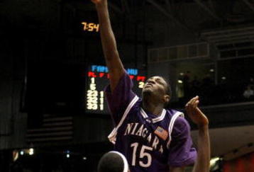 DAYTON, OH - MARCH 13:  Benson Egemonye #15 of the  Niagara Purple Eagles tries to get a shot off over Akini Adkins #33 of the Florida A&M Rattlers during the opening round of the Men's NCAA Tournament on March 13, 2007 at the University of Dayton Arena in Dayton, Ohio.  (Photo by Gregory Shamus/Getty Images)