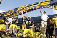 ANN ARBOR, MI - SEPTEMBER 05:  Head coach Rich Rodriguez enters the stadium with his team prior to playing the Western Michigan Broncos on September 5, 2009 at Michigan Stadium in Ann Arbor, Michigan.  (Photo by Gregory Shamus/Getty Images)