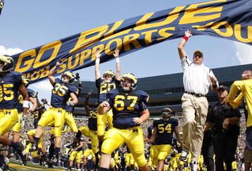ANN ARBOR, MI - SEPTEMBER 05:  Head coach Rich Rodriguez enters the stadium with his team prior to playing the Western Michigan Broncos on September 5, 2009 at Michigan Stadium in Ann Arbor, Michigan.  (Photo by Gregory Shamus/Getty Images)