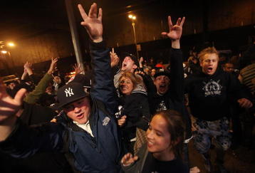 NEW YORK - NOVEMBER 04:  Yankees fans celebrate outside Yankee Stadium following the New York Yankees victory over the Philadelphia Phillies in Game Six of the 2009 MLB World Series on November 4, 2009 in the Bronx borough of New York City.The Yankees defeated the Phillies 7-3 to win their 27th championship.  (Photo by Mario Tama/Getty Images)