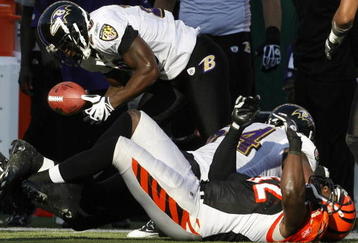 CINCINNATI - NOVEMBER 8:  Ed Reed # 20 of the Baltimore Ravens fumbles the football after be hit by Adbul Hodge #52 of the Cincinnati Bengals at Paul Brown Stadium on November 8, 2009 in Cincinnati, Ohio.  (Photo by John Sommers II/Getty Images)