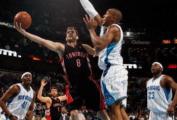 NEW ORLEANS - FEBRUARY 06:  Jose Calderon #8 of the Toronto Raptors makes a shot around David West #30 of the New Orleans Hornets on February 6, 2009 in New Orleans, Louisiana. The Hornets defeated the Raptors 101-92.   NOTE TO USER: User expressly acknowledges and agrees that, by downloading and/or using this Photograph, user is consenting to the terms and conditions of the Getty Images License Agreement.  (Photo by Chris Graythen/Getty Images)