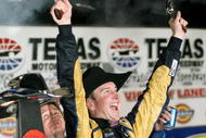 FORT WORTH, TX - NOVEMBER 08: Kurt Busch, driver of the #2 Miller Lite Dodge, celebrates by firing two Beretta's into the air on victory lane after winning the NASCAR Sprint Cup Series Dickies 500 at Texas Motor Speedway on November 8, 2009 in Fort Worth, Texas. (Photo by Tom Pennington/Getty Images for NASCAR)