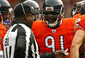CHICAGO - NOVEMBER 01: Tommie Harris #91 of the Chicago Bears jokes with umpire Roy Ellison #81 during a game against the Cleveland Browns at Soldier Field on November 1, 2009 in Chicago, Illinois. The Bears defeated the Browns 30-6. (Photo by Jonathan Daniel/Getty Images)