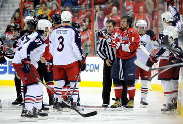 WASHINGTON - NOVEMBER 01:  Alex Ovechkin #8 of the Washington Capitals is escorted to the penalty box after receiving a roughing penalty in the second period against the Columbus Blue Jackets at the Verizon Center on November 1, 2009 in Washington, DC.  (Photo by Greg Fiume/Getty Images)