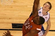 GREENSBORO, NC - MARCH 21: Kyle Singler #12 of the Duke Blue Devils defends the basket against Dexter Pittman #34 of the Texas Longhorns during the second round of the NCAA Division I Men's Basketball Tournament at the Greensboro Coliseum on March 21, 2009 in Greensboro, North Carolina. (Photo by Streeter Lecka/Getty Images)