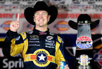 FORT WORTH, TX - NOVEMBER 08:  Kurt Busch, driver of the #2 Miller Lite Dodge, poses with the trophy on victory lane after winning the NASCAR Sprint Cup Series Dickies 500 at Texas Motor Speedway on November 8, 2009 in Fort Worth, Texas.  (Photo by Rusty Jarrett/Getty Images for NASCAR)