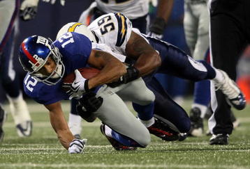 EAST RUTHERFORD, NJ - NOVEMBER 08:  Steve Smith #12 of the New York Giants is tackled Brandon Siler #59 of the San Diego Chargers at Giants Stadium on November 8, 2009 in East Rutherford, New Jersey.  (Photo by Nick Laham/Getty Images)