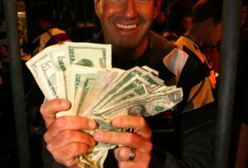 DAVIDSON, NC - OCTOBER 14:  NASCAR driver Marcos Ambrose shows money raised after he was locked up for charity at the NASCAR Second Annual Jail & Bail held at Brickhouse Tavern  October 14, 2009 in Davidson, North Carolina.  Funds raised during the event will go to The NASCAR Foundation and Brienne Davis Scholarship Fund.  (Photo by Jason Smith/Getty Images)