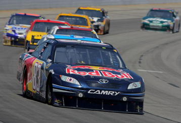 LONG POND, PA - AUGUST 03:  Brian Vickers, driver of the #83 Red Bull Toyota, races to a sixth place finish in the NASCAR Sprint Cup Series Sunoco Red Cross Pennsylvania 500 at the Pocono Raceway on August 3, 2009 in Long Pond, Pennsylvania.  (Photo by Doug Pensinger/Getty Images)
