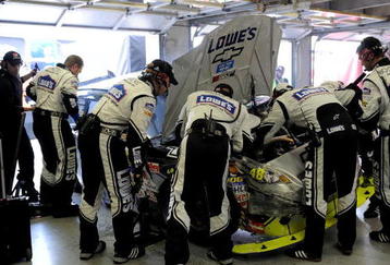 FORT WORTH, TX - NOVEMBER 08:  Crew members for Jimmie Johnson, driver of the #48 Lowe's Chevrolet, work on the car after being involved in a crash with Sam Hornish Jr., driver of the #77 AAA Dodge, during the NASCAR Sprint Cup Series Dickies 500 at Texas Motor Speedway on November 8, 2009 in Fort Worth, Texas.  (Photo by Rusty Jarrett/Getty Images for NASCAR)