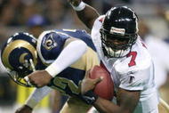 6 Jan 2002: Michael Vick #7 of the Atlanta Falcons scrambles as Chidi Ahanotu #72 of the St. Louis Rams defends at the Dome at America's Center in St. Louis, Missouri. The St. Louis Rams beat the Atlanta Falcons 31-13. DIGITAL IMAGE. Mandatory Credit: Elsa /Getty Images