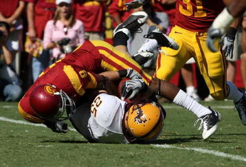 LOS ANGELES, CA - OCTOBER 11: Linebacker Mike Nixon #25 of the Arizona State Sun Devils is tackled by wide receiver Ronald Johnson #8  after maiking an interception on October 10, 2008 at the Los Angeles Coliseum in Los Angeles, California.  usc WON 28-0.  (Photo by Stephen Dunn/Getty Images)
