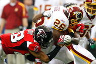 ATLANTA - NOVEMBER 08: Clinton Portis #26 of the Washington Redskins rushes upfield against Thomas DeCoud #28 of the Atlanta Falcons at Georgia Dome on November 8, 2009 in Atlanta, Georgia. (Photo by Kevin C. Cox/Getty Images)
