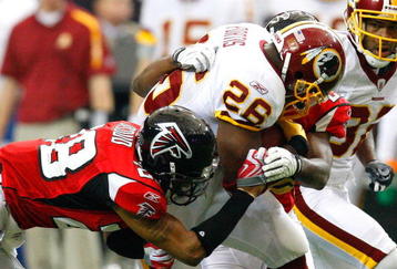 ATLANTA - NOVEMBER 08:  Clinton Portis #26 of the Washington Redskins rushes upfield against Thomas DeCoud #28 of the Atlanta Falcons at Georgia Dome on November 8, 2009 in Atlanta, Georgia.  (Photo by Kevin C. Cox/Getty Images)