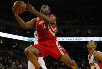OAKLAND, CA - DECEMBER 12:  Carl Landry #14 of the Houston Rockets lays the ball up past Anthony Randolph #4 of the Golden State Warriors during the game on December 12, 2008 at Oracle Arena in Oakland, California.  The Rockets won 119-108.  NOTE TO USER: User expressly acknowledges and agrees that, by downloading and or using this photograph, User is consenting to the terms and conditions of the Getty Images License Agreement.  (Photo by Jed Jacobsohn/Getty Images)