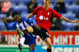 WIGAN, UNITED KINGDOM - NOVEMBER 08: Jason Scotland of Wigan Athletic and Brede Hangeland of Fulham head for the ball during the Barclays Premier League match between Wigan Athletic and Fulham at DW Stadium on November 08, 2009 in Wigan, England. (Photo by Tom Dulat/Getty Images)