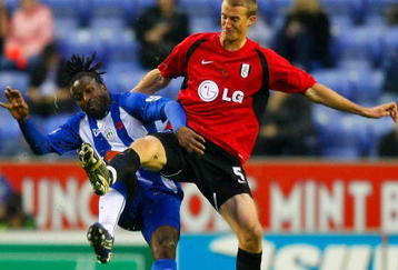 WIGAN, UNITED KINGDOM - NOVEMBER 08: Jason Scotland of Wigan Athletic and Brede Hangeland of Fulham head for the ball during the Barclays Premier League match between Wigan Athletic and Fulham at DW Stadium on November 08, 2009 in Wigan, England. (Photo by Tom Dulat/Getty Images)