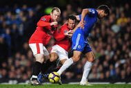 LONDON, ENGLAND - NOVEMBER 08: Michael Ballack of Chelsea battles for the ball with Wayne Rooney (L) and Ryan Giggs of Manchester United during the Barclays Premier League match between Chelsea and Manchester United at Stamford Bridge on November 8, 2009 in London, England. (Photo by Clive Mason/Getty Images)