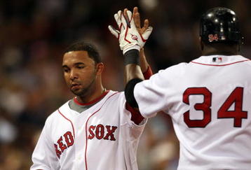 BOSTON - SEPTEMBER 08:  Alex Gonzalez #3 of the Boston Red Sox is congratulated by David Ortiz #34 after Gonzalez scored against the Baltimore Orioles on September 8, 2009 at Fenway Park in Boston, Massachusetts.  (Photo by Elsa/Getty Images)