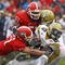 ATHENS, GA - NOVEMBER 29:  Defensive teammates Chad Gloer #17 and Akeem Dent #51 of the Georgia Bulldogs tackle running back Roddy Jones #20 of the Georgia Tech Yellow Jackets while Jones' teammate Marcus Wright #3 tries to block during the game at Sanford Stadium on November 29, 2008 in Athens, Georgia.  The Yellow Jackets defeated the Bulldogs 45-42.  (Photo by Mike Zarrilli/Getty Images)