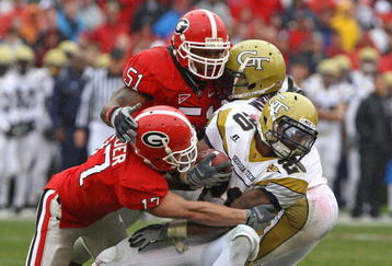 ATHENS, GA - NOVEMBER 29:  Defensive teammates Chad Gloer #17 and Akeem Dent #51 of the Georgia Bulldogs tackle running back Roddy Jones #20 of the Georgia Tech Yellow Jackets while Jones' teammate Marcus Wright #3 tries to block during the game at Sanford Stadium on November 29, 2008 in Athens, Georgia.  The Yellow Jackets defeated the Bulldogs 45-42.  (Photo by Mike Zarrilli/Getty Images)