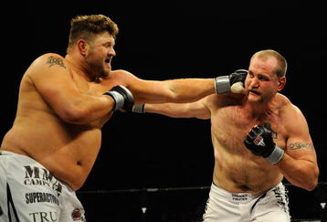 UNCASVILLE, CT - MAY 16:  Roy Nelson (L) of the Lions Den throws a punch at Brad Imes (R) MilesTech Fighting System during their bout presented by the International Fighting League at the Mohegan Sun Arena May 16, 2008 in Uncasville, Connecticut.  (Photo by Jeff Zelevansky/Getty Images for IFL)