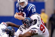 INDIANAPOLIS - NOVEMBER 08:  Peyton Manning #18 of the Indianapolis Colts is sacked by Mario Williams #90 the Houston Texans at Lucas Oil Stadium on November 8, 2009 in Indianapolis, Indiana.  The Colts won 20-17.  (Photo by Andy Lyons/Getty Images)