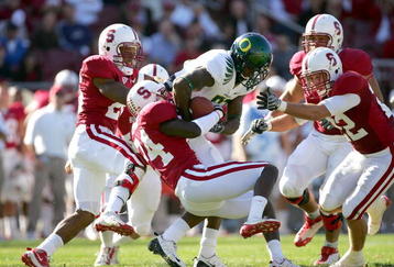 PALO ALTO, CA - NOVEMBER 07:  Kris Evans #24 of the Stanford Cardinal tackles Ed Dickson #83 of the Oregon Ducks at Stanford Stadium on November 7, 2009 in Palo Alto, California.  (Photo by Ezra Shaw/Getty Images)