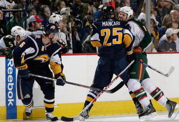 BUFFALO, NY - SEPTEMBER 28:  Craig Weller #12 of the Minnesota Wild checks Mark Mancari #25 of the Buffalo Sabres during their NHL preseason NHL game on September 28, 2008 at HSBC Arena in Buffalo, New York. The Wild defeated the Sabres 2-1 in shootout overtime. (Photo by Rick Stewart/Getty Images)