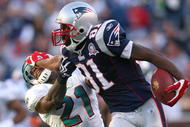 FOXBORO, MA - NOVEMBER 8: Randy Moss #81 of the New England Patriots gains yards against the defense of Vontae Davis of the Miami Dolphins at Gillette Stadium on November 8, 2009 in Foxboro, Massachusetts. The Patriots won 27-17. (Photo by Jim Rogash/Getty Images)