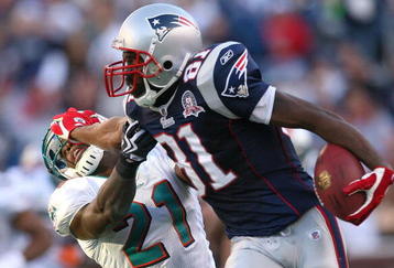FOXBORO, MA - NOVEMBER 8:  Randy Moss #81 of the New England Patriots gains yards against the defense of Vontae Davis of the Miami Dolphins at Gillette Stadium on November 8, 2009 in Foxboro, Massachusetts. The Patriots won 27-17. (Photo by Jim Rogash/Getty Images)