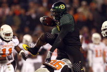SAN DIEGO, CA - DECEMBER 30:   Runningback LeGarrette Blount #9 of the University of Oregon Ducks hurdles a player en route to a touchdown during his team's 42-31 win over the Oklahoma State University Cowboys in the Pacific Life Holiday Bowl at Qualcomm Stadium on December 30, 2008 in San Diego, California. (Photo by Donald Miralle/Getty Images)