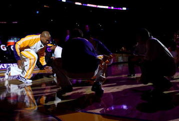 LOS ANGELES - NOVEMBER 8:  Derek Fisher #2 of the Los Angeles Lakers goes low to greet teammates during pregame introductions for the game with the New Orleans Hornets on November 8, 2009 at Staples Center in Los Angeles, California.   The Lakers won 104-88.  NOTE TO USER: User expressly acknowledges and agrees that, by downloading and/or using this Photograph, user is consenting to the terms and conditions of the Getty Images License Agreement.   (Photo by Stephen Dunn/Getty Images)