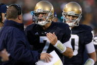 SOUTH BEND, IN - OCTOBER 17: Head coach Charlie Weis of the Notre Dame Fighting Irish speaks to quarterback Jimmy Clausen #7 during the fourth quarter against the USC Trojans at Notre Dame Stadium on October 17, 2009 in South Bend, Indiana. USC won the game 34-27. (Photo by Jonathan Daniel/Getty Images)