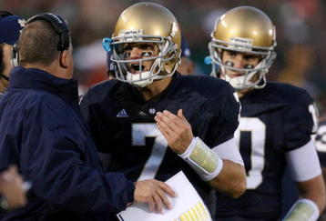 SOUTH BEND, IN - OCTOBER 17: Head coach Charlie Weis of the Notre Dame Fighting Irish speaks to quarterback Jimmy Clausen #7 during the fourth quarter against the USC Trojans at Notre Dame Stadium on October 17, 2009 in South Bend, Indiana. USC won the game 34-27. (Photo by Jonathan Daniel/Getty Images)