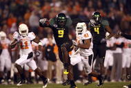 SAN DIEGO, CA - DECEMBER 30:   Runningback LeGarrette Blount #9 of the University of Oregon Ducks hurdles a player en route to a touchdown during his team's 42-31 win over the Oklahoma State University Cowboys in the Pacific Life Holiday Bowl at Qualcomm Stadium on December 30, 2008 in San Diego, California. (Photo by Donald Miralle/Getty Images)
