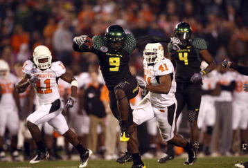 SAN DIEGO, CA - DECEMBER 30:   Runningback LeGarrette Blount #9 of the University of Oregon Ducks hurdles a player en route to a touchdown during his team's 42-31 win over the Oklahoma State University Cowboys in the Pacific Life Holiday Bowl at Qualcomm Stadium on December 30, 2008 in San Diego, California. (Photo by Donald Miralle/Getty Images)