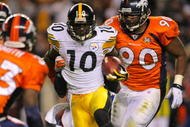 DENVER - NOVEMBER 09: Santonio Holmes #10 of the Pittsburgh Steelers runs with the ball against  Alphonso Smith #33 and Travis Kirschke #90 of the Denver Broncos at Invesco Field at Mile High on November 09, 2009 in Denver, Colorado. (Photo by Doug Pensinger/Getty Images)